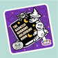 Sticker of 'The Haunted Horrors Colouring Book' with a skeleton and pumpkin on a purple background.